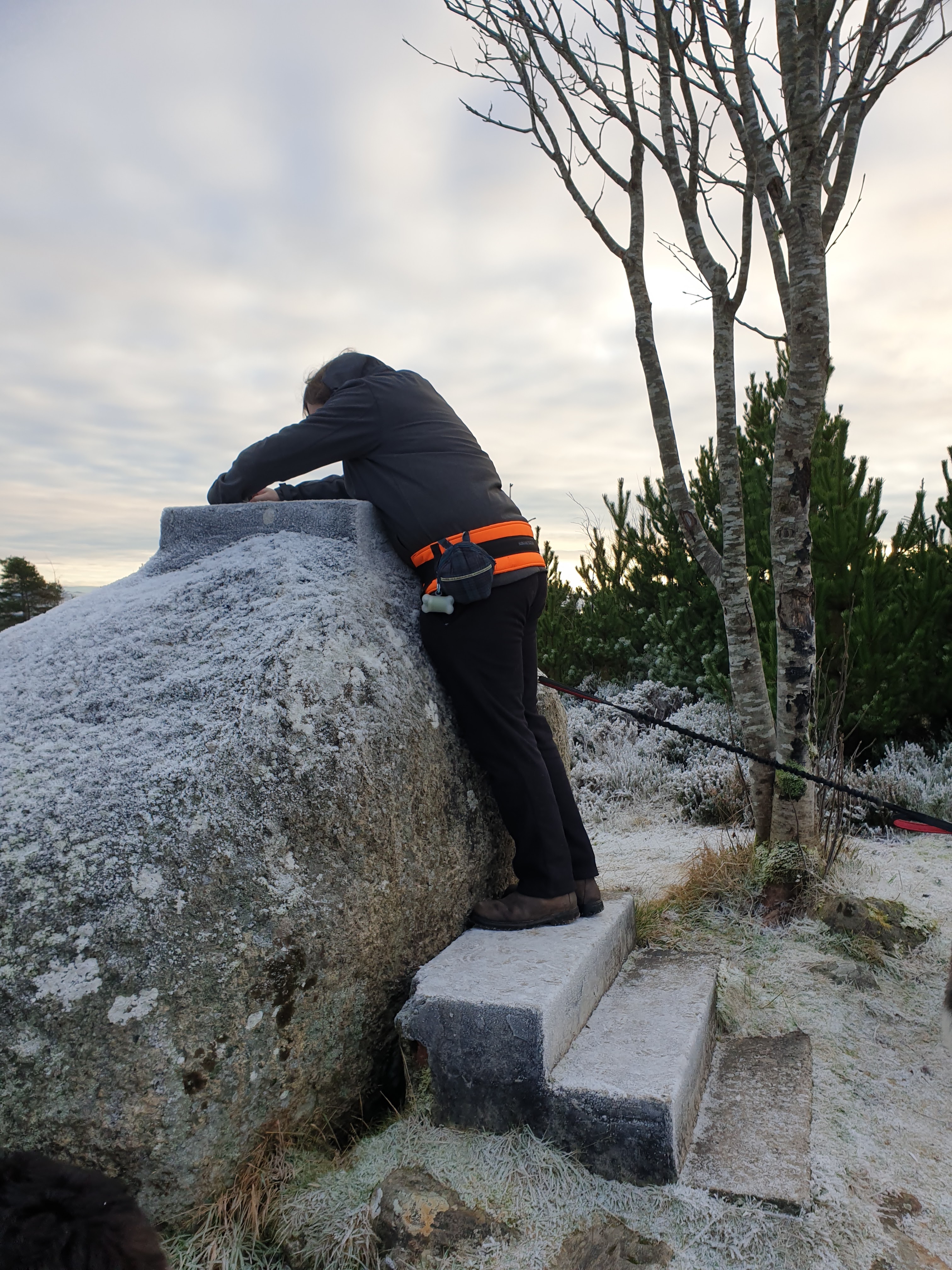 James leaning on Pulpit Rock to get photo of view - too much frost to climb on it 